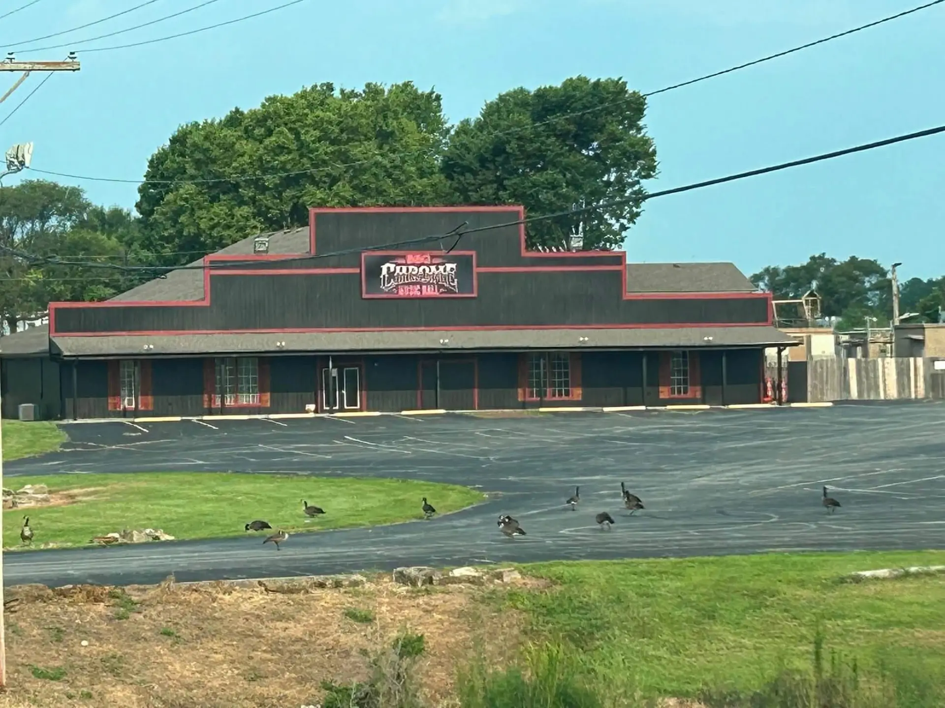 Chrome's black building with red trim and its parking lot in daylight